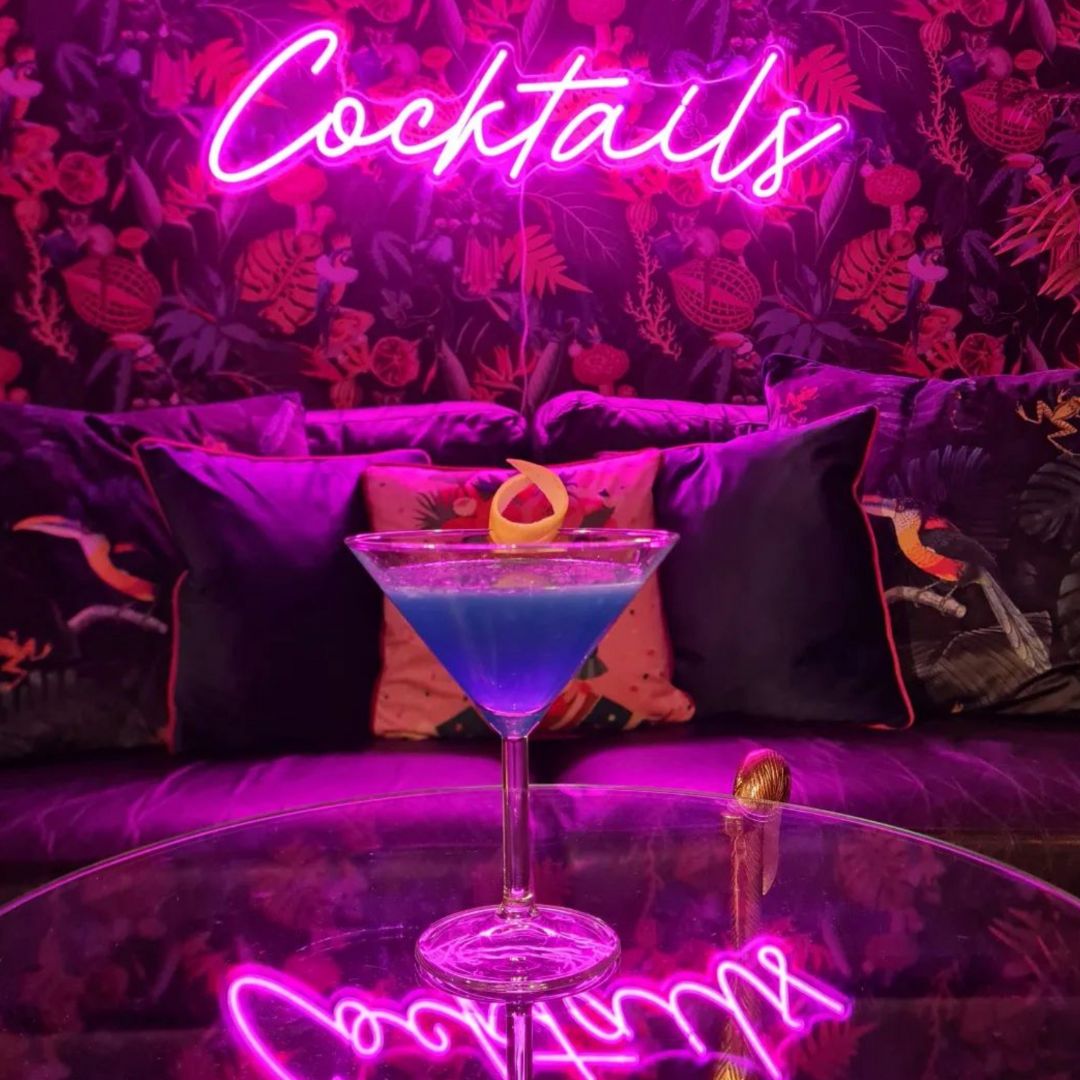 Pink Cocktails neon bar sign with blue cocktail.