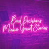 Pinl "Bad decisions make great stories" neon bar sign on brick wall.