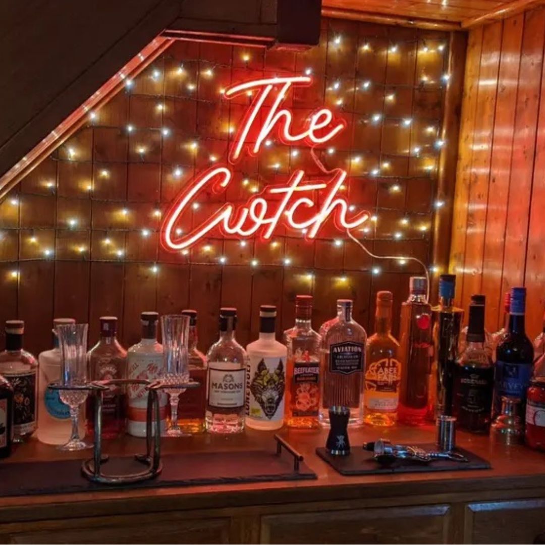 Home bar with bottles of alcohol and red 