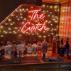 Home bar with bottles of alcohol and red "The Cwtch" custom neon bar sign