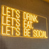 Yellow "Let's drink, let's eat, let's be social" neon bar sign