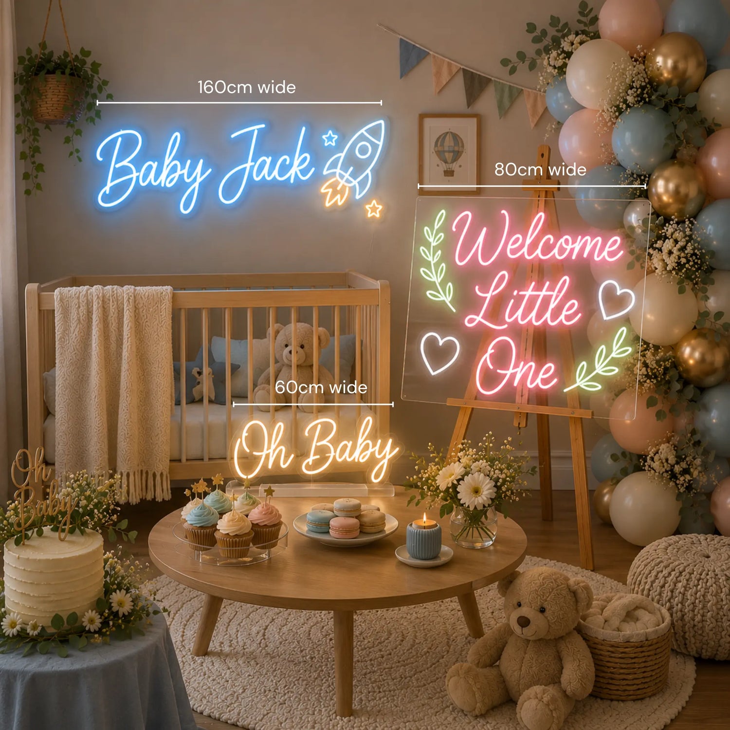 A styled baby shower or nursery party scene with neon sign lights mounted on a wall and on a table. The signs read 'Baby Jack', 'Welcome Little One', and 'Oh Baby' in glowing blue, pink, and yellow lettering.