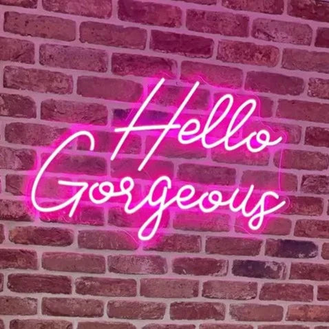 Hello Gorgeous Neon Sign against brick wall