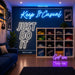 A styled room scene showing a blue wall with neon-style text reading 'Keep It Casual' and 'JUST DO IT,' plus size annotations '160cm wide,' '80cm wide,' and '60cm wide.' A white shoe rack filled with colorful sneakers stands against the wall, with additional neon text 'Got em' and '60cm wide' below.
