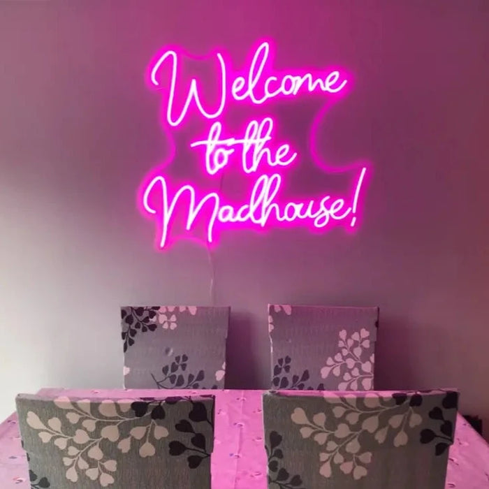 Pink Welcome to the madhouse neon sign