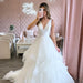 Woman posing in wedding dress in pink room with White Happily Every After Neon Sign by pearlsandlacebb