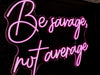 Be Savage, Not Average Neon Sign in love potion pink. Photo by CrossFit Alhaurin