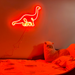 Hot Mama Red single line Diplodocus Dinosaur Neon Sign mounted on the wall above a child's bed