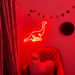 Hot Mama Red single line Diplodocus Dinosaur Neon Sign mounted on the wall of a child's playrooms