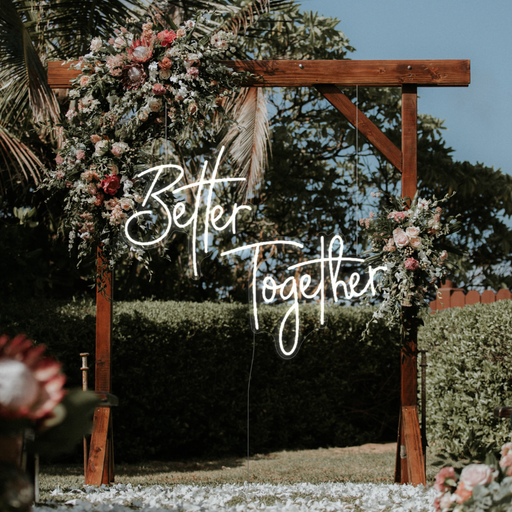 White "Better Together" neon sign at wedding ceremony
