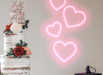 Pastel pink Floating Hearts Neon Sign behind a wedding cake