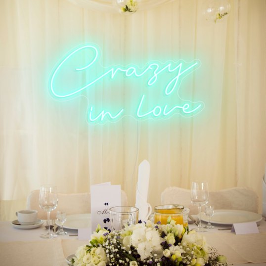 Ice blue crazy in love neon sign over a wedding table